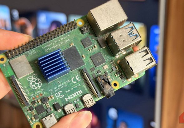 a-raspberry-pi-4-held-in-front-of-a-smart-tv