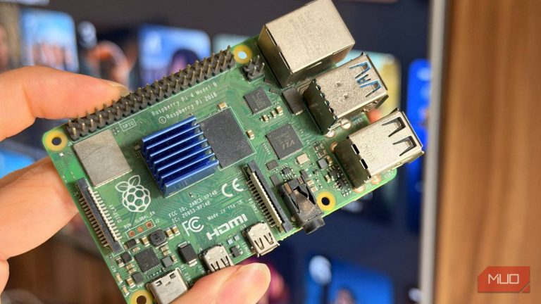 a-raspberry-pi-4-held-in-front-of-a-smart-tv